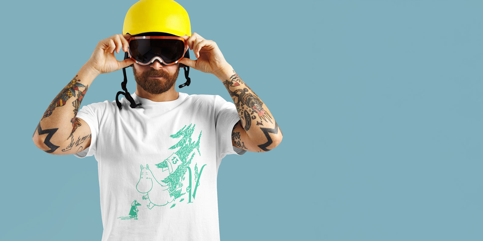 A man in SKi Goggles wearing a Green Moomintroll Apres Ski Winter Sports Games Adult T-Shirt